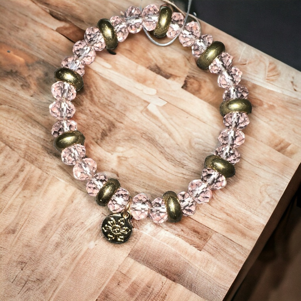 Clear pink & gold beaded bracelet with small gold charm